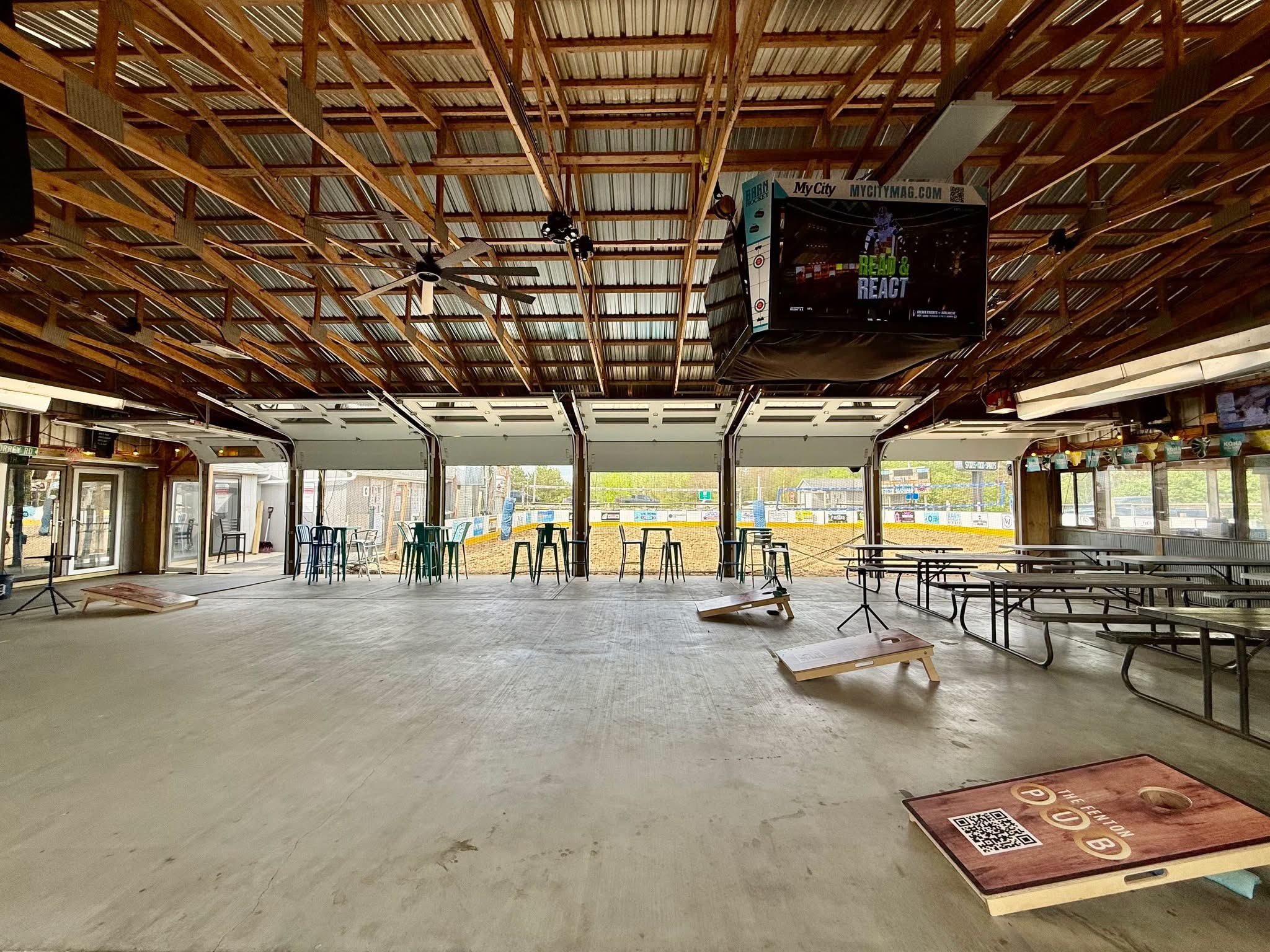 The Barn's Event Patio with cornhole boards set up